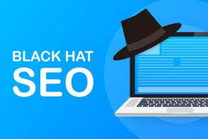 The words Black Hat SEO next to a Black Hat hanging off the side of a laptop.