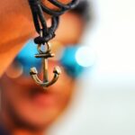 selective focus photography of anchor pendant